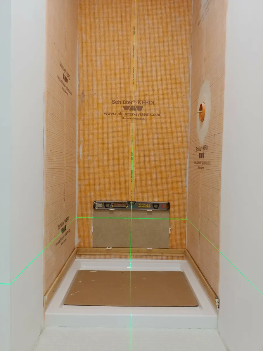Shower walls and pan waterproofed with orange membrane before tile