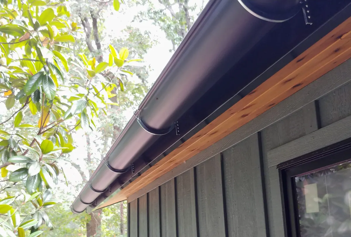 Board-and-batten siding with wood soffit and half-round gutters